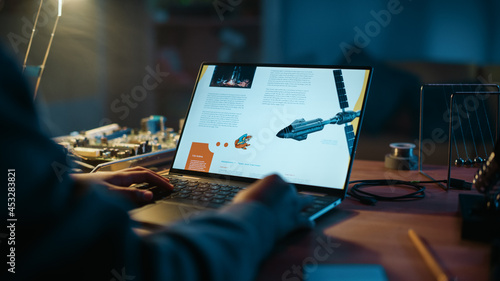 Photos Close Up of a Young Person Studying Science Topic About Robotics at Home
