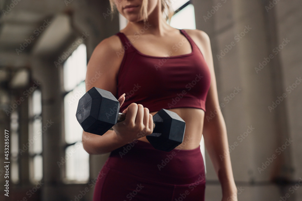 Strong woman working out with dumbbell Strong woman working out with dumbbell