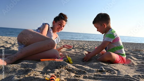 Young mother spends time with her child, near the sea 