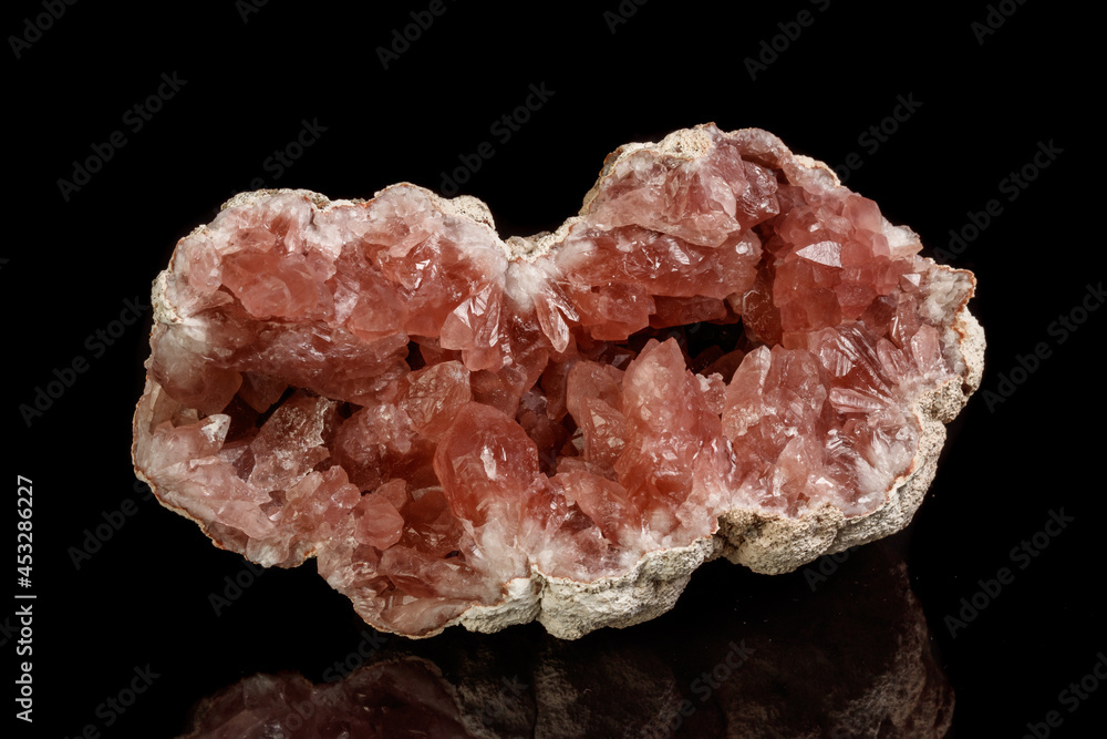 Macro mineral stone Pink Amethyst on a black background