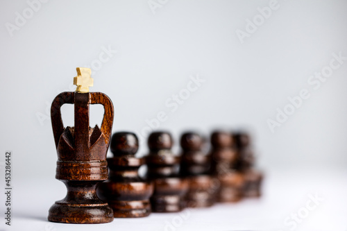 Pawns behind a king on a chess board.