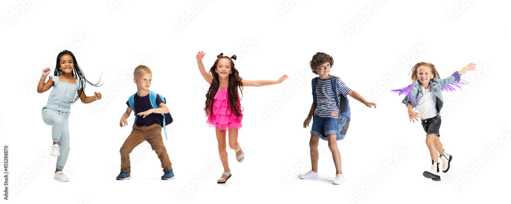 Horizontal collage made of portraits of little happy kids running isolated on white studio background. Human emotions, facial expression concept