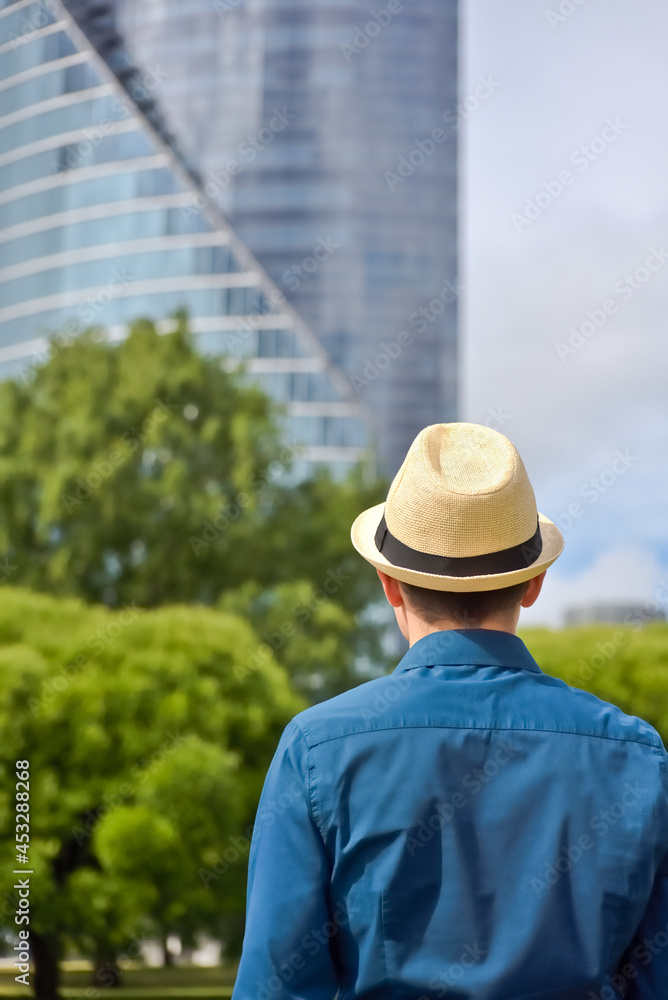 Young student, programmer and businessman looks at office building and thinks about work and career.
