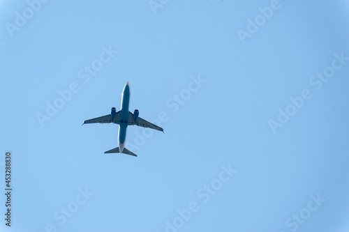 A beautiful plane is flying in the blue sky
