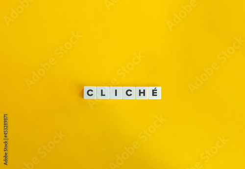 Cliché word on block letter tiles. Minimal aesthetics. photo