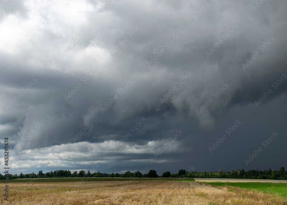Fototapeta premium landscape with storm clouds, contrasting colors in nature before rain, autumn approaching time