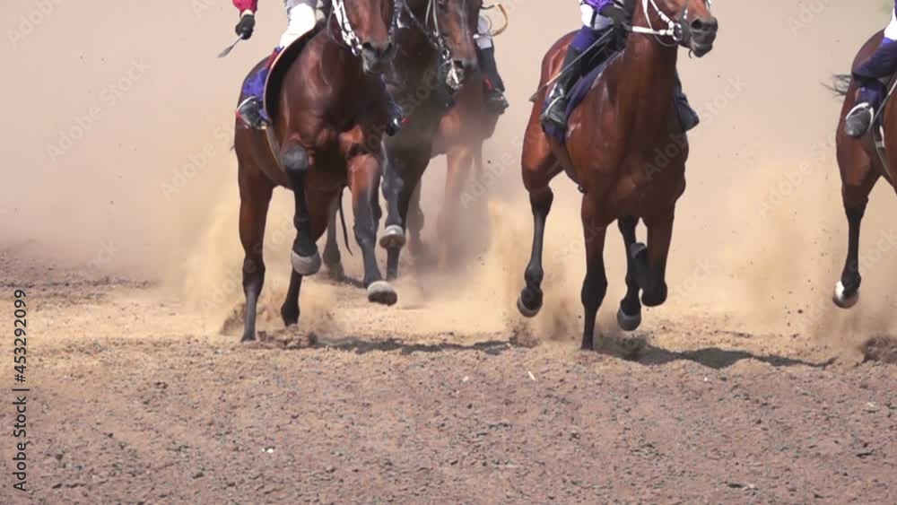 Horse Racing. The Feet of the Horses at the Racetrack Raising Dust and Dirt. Close Up. Slow motion. Horse Racing. The Feet of the Horses at the Racetrack Raising Dust and Dirt. Close Up. Slow motion.