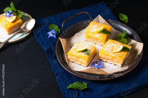 Food concept Homemade rustic Lemon bar pie on black background with copy space