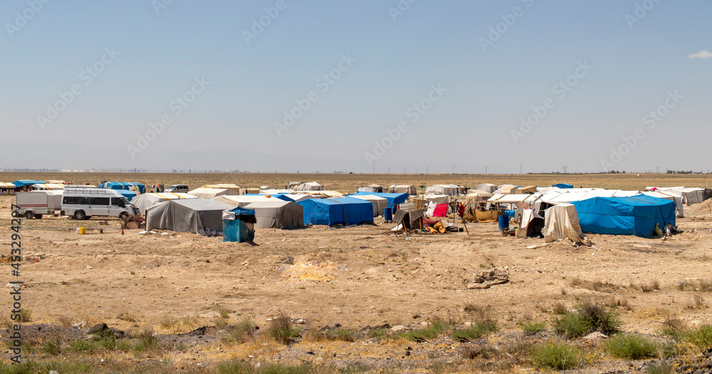 migrant tents, refugee camps. seasonal worker tents in an open area. migrant tents, refugee camps. seasonal worker tents in an open area.