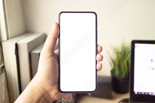 Wallpaper Mural Hand holding or using smartphone with one hand. Smartphone with white blank on screen, Cellphone mockup. Torontodigital.ca