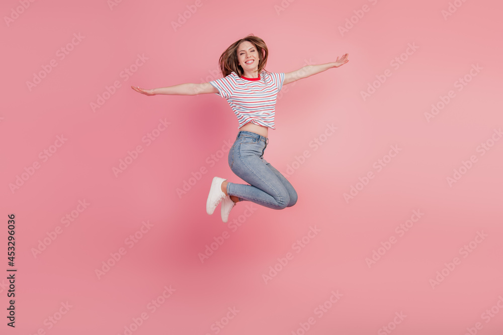 Portrait of stunning crazy energetic lady jump active lifestyle on pink background