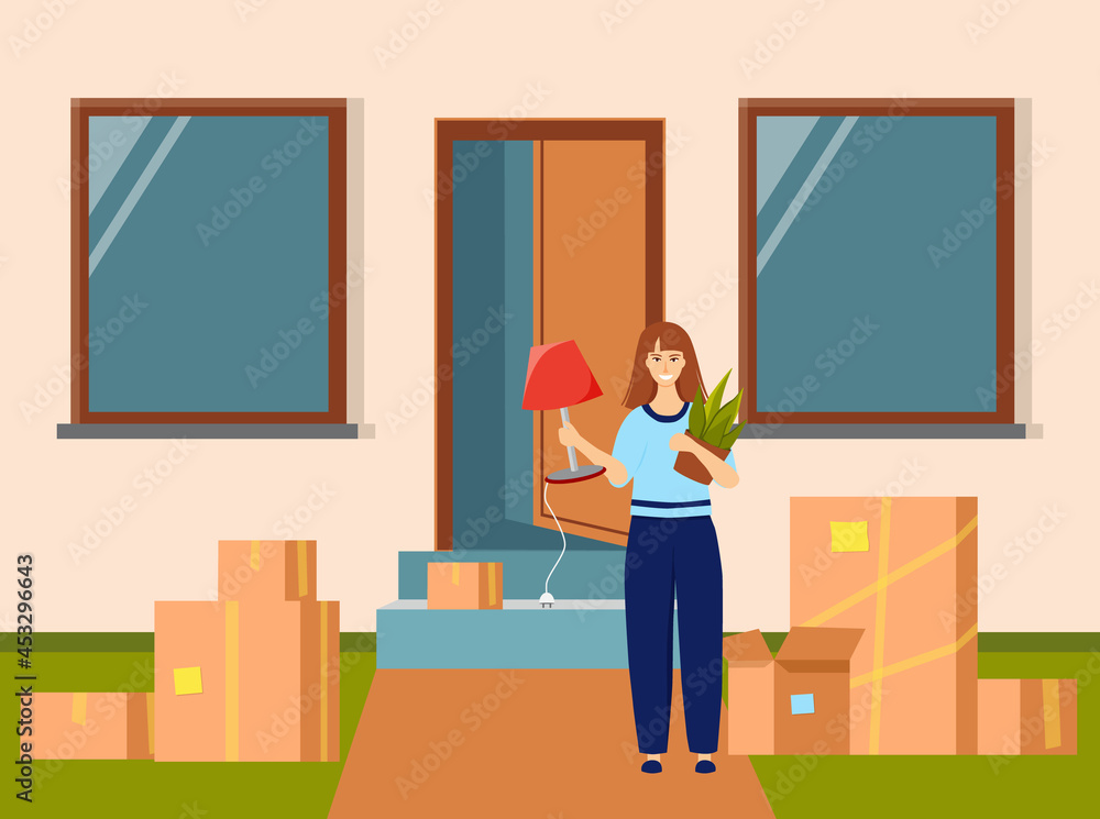 A smiling girl stands with a flower and a lamp in her hands in front of the entrance to a new house. Packaging boxes are standing nearby. Moving to a new home. Vector illustration in flat style. A smiling girl stands with a flower and a lamp in her hands in front of the entrance to a new house. Packaging boxes are standing nearby. Moving to a new home. Vector illustration in flat style.