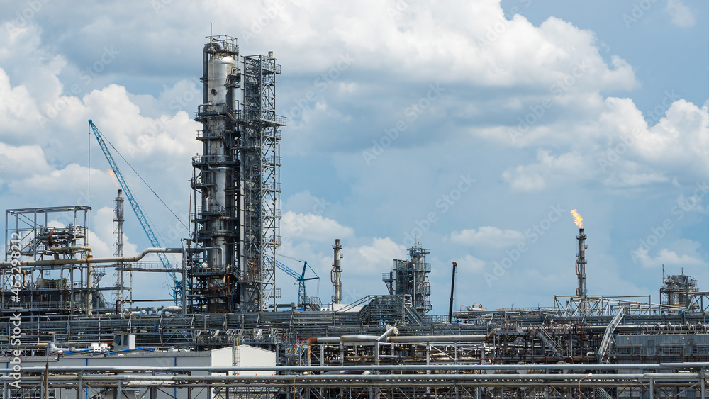 Industrial view at oil refinery plant form industry zone with cloudy sky. Industry concept.