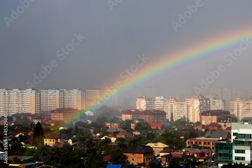 Rainbow in the rain over the city