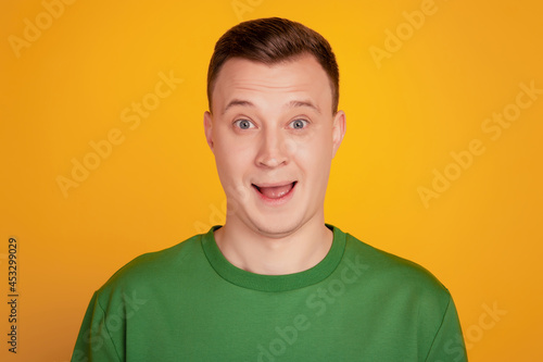 Portrait of amazed funky nice guy open mouth omg reaction on yellow background
