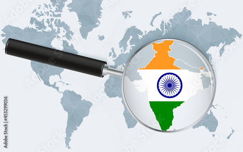 World map with a magnifying glass pointing at India. Map of India with the flag in the loop.