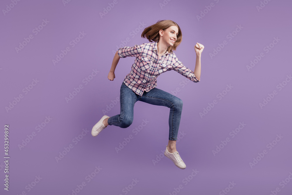 Full length side profile body size photo girl jump up go run hurry sale discount isolated violet color background Full length side profile body size photo girl jump up go run hurry sale discount isolated violet color background