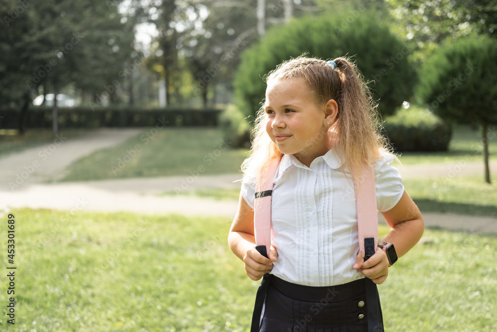 happy blonde curly schoolgirl in school uniform with pink backpack back to school outdoor happy blonde curly schoolgirl in school uniform with pink backpack back to school outdoor