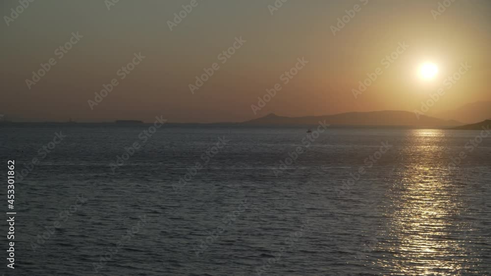 View of sun rays reflection in sea before sunset View of sun rays reflection in sea before sunset