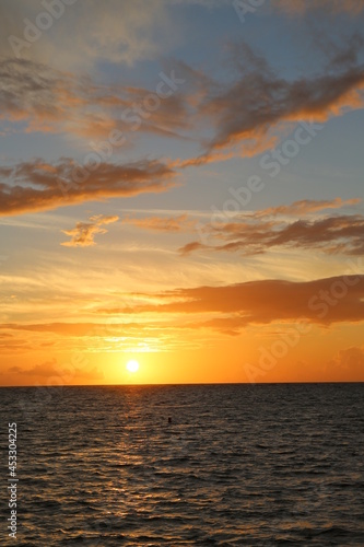 Beautiful yellow sunset over the ocean and different color sky