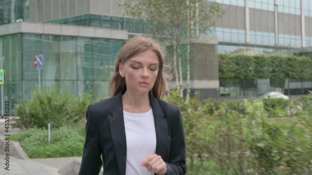 Young Businesswoman Walking on the Street in Slow Motion Young Businesswoman Walking on the Street in Slow Motion