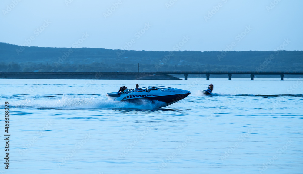 Silhouette of motorboat running on the river Silhouette of motorboat running on the river