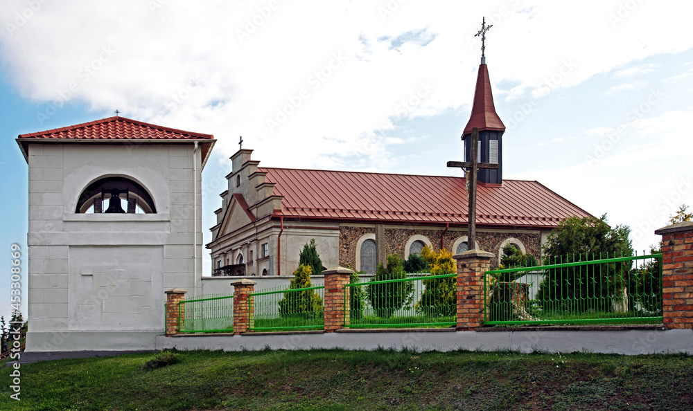 General view and architectural details of the built in 1840 together with the belfry. Classicist Catholic Church of St. Adalbert in the village of Poryte in Podlasie, Poland.