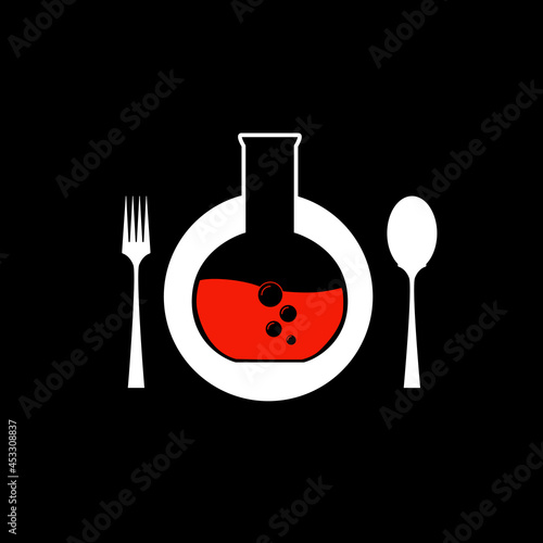flask with red liquid and bubbles on a plate, a fork and a spoon lie next to it