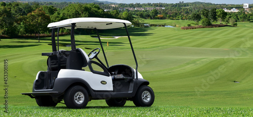 golf cart parking on road at golf course with beautiful twilight sky background, summer color style.	
