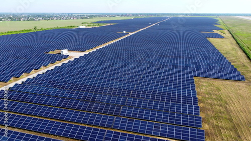 Aerial drone view flight over solar power station panels.