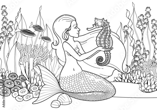 Graphic mermaid sits on the sandy ocean bottom and plays with the seahorses