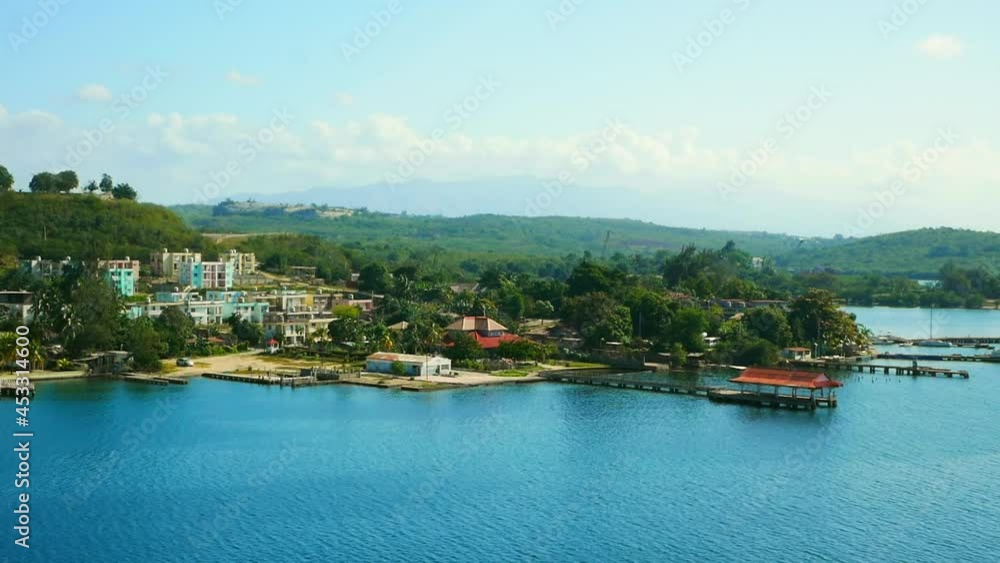 View on the rich colorful villas and buildings outside city Santiago De Cuba on the the seashore on the bay. View on the rich colorful villas and buildings outside city Santiago De Cuba on the the seashore on the bay.