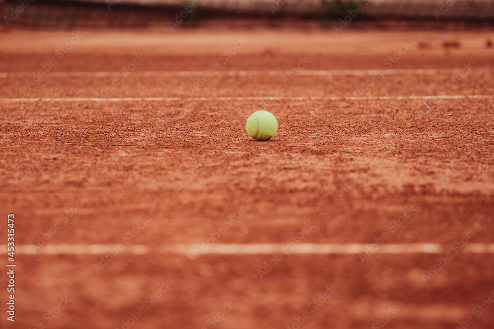 A tennis ball stops in the center of a clay court image during a tennis game