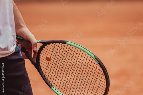 detail of tennis racket held in the hand by a young athlete © Vamos Sports Prod