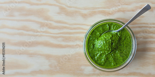 Bowl with green chutney sauce dip from coriander leaves. Top view with copy space.