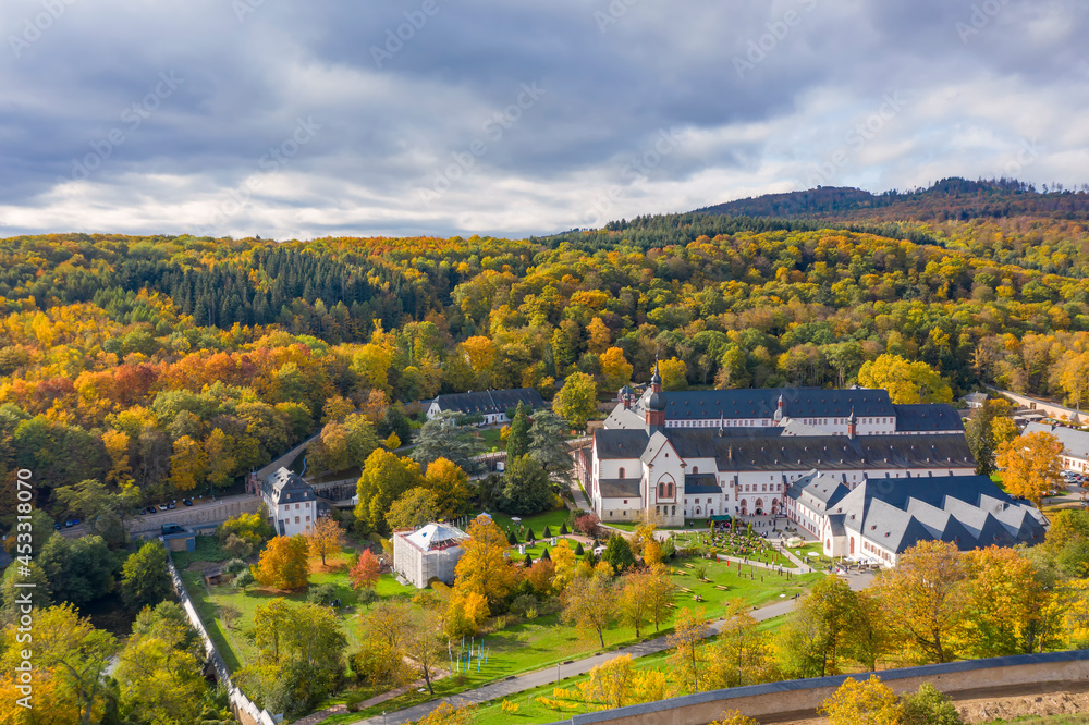 Bird's eye view of Eberbach Monastery near Kiedrich / Germany in the autumn-colored forest 
