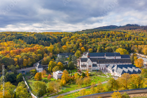 Bird's eye view of Eberbach Monastery near Kiedrich / Germany in the autumn-colored forest 