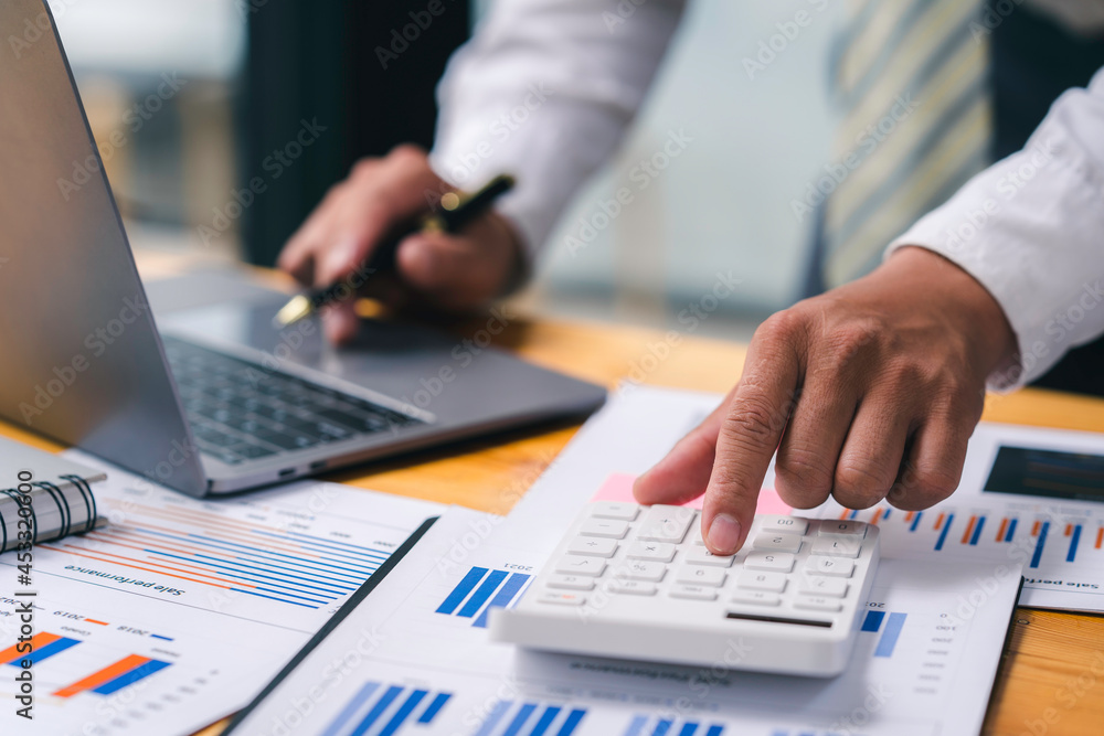 Accountant doing finance and calculate about cost on the desk at home Accountant doing finance and calculate about cost on the desk at home