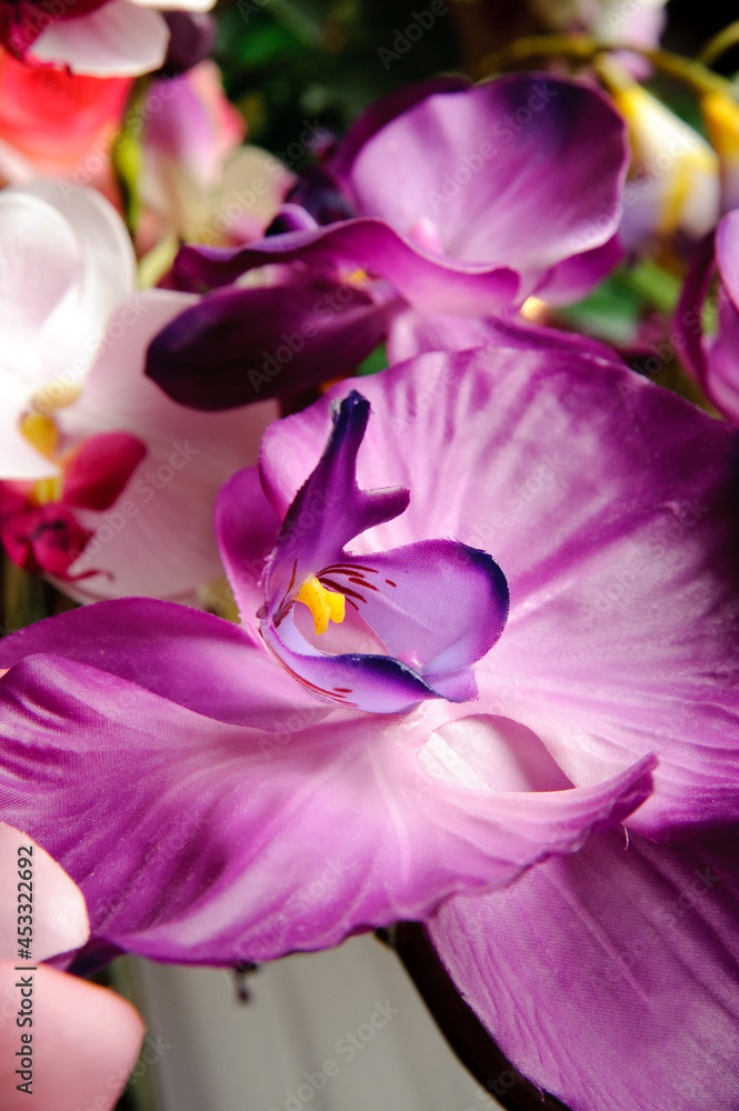 Close up of a violet plastic orchid