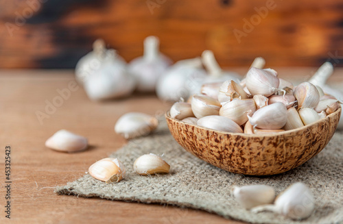 Garlic Cloves and Bulb in wooden bowl.