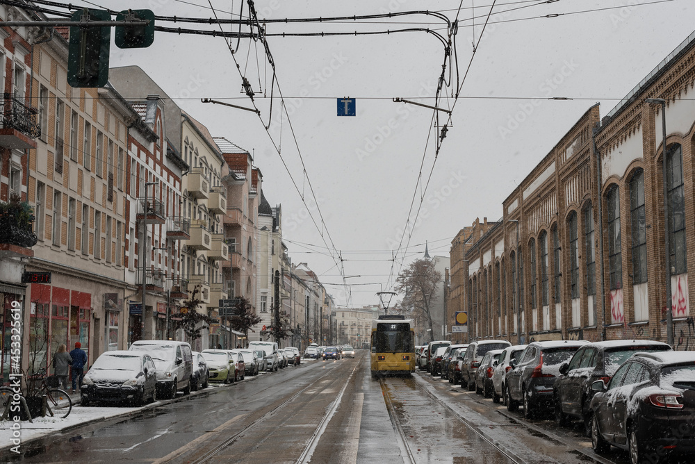 Tram in Berlin Schöneweide in winter, a street in wintry Berlin, snowfall