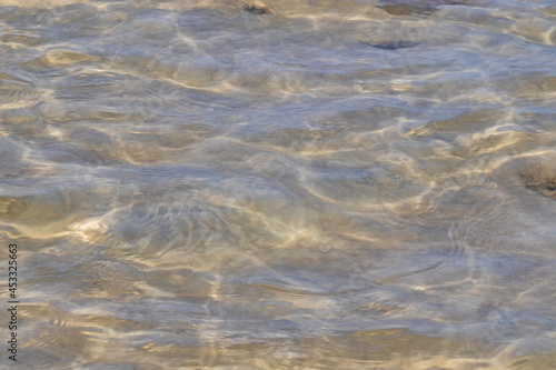 Ripples in the water. sandy bottom of the river.