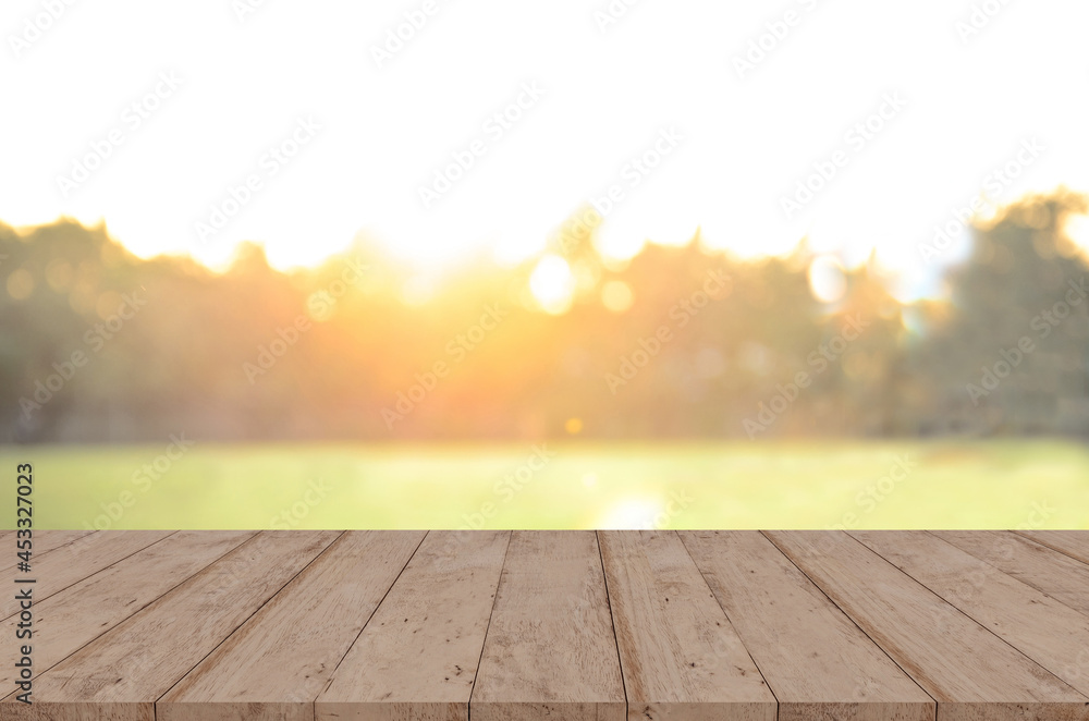 Wood tabletop in front of trees in the forest. sunset blur background image, for product display montage.