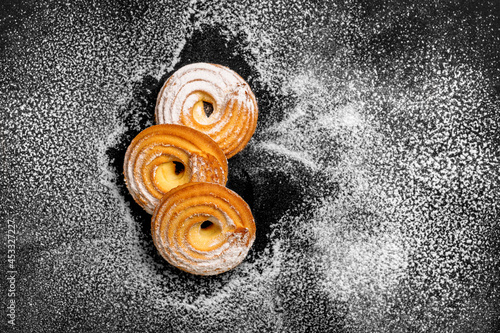 Top view different cookies on table top, Flat lay of cookies on black background, Prepared cookies food buffet on table for serve photo