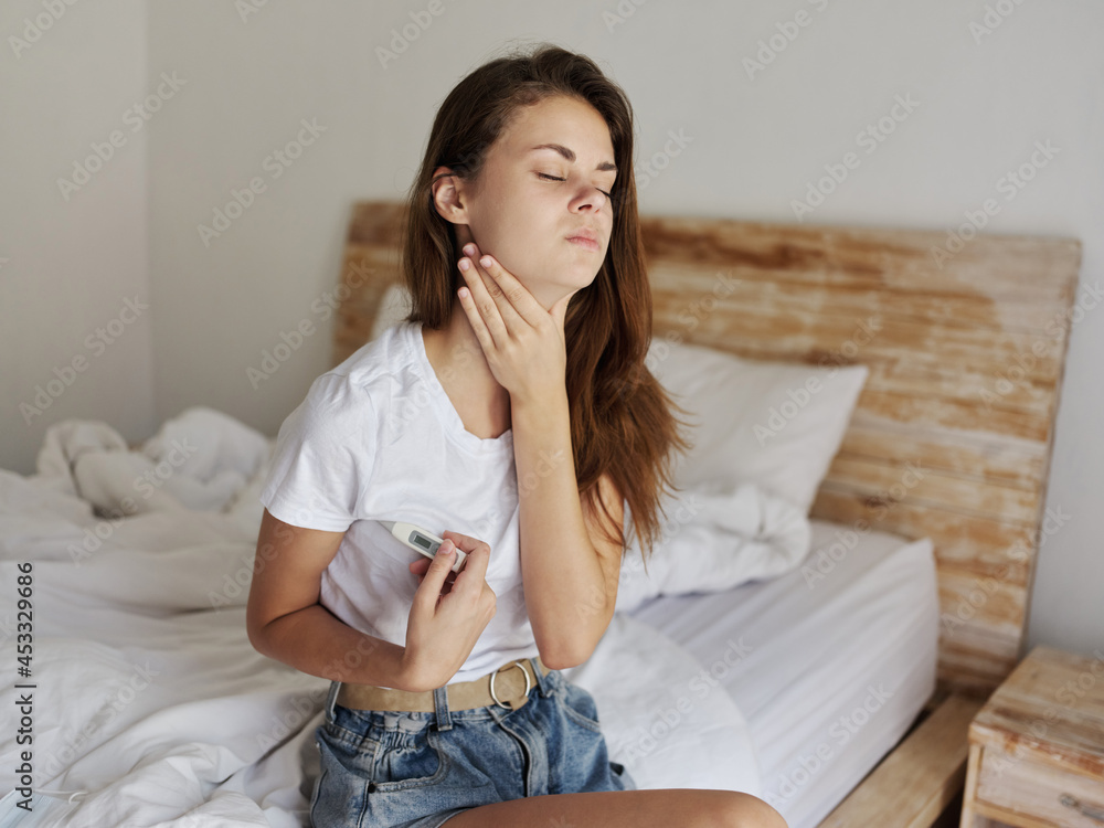woman holding throat with thermometer armpit checking temperature woman holding throat with thermometer armpit checking temperature