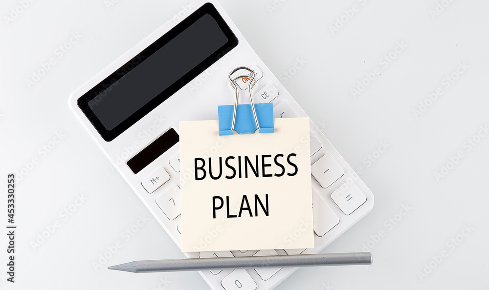 Business plan text on the sticker on white calculator