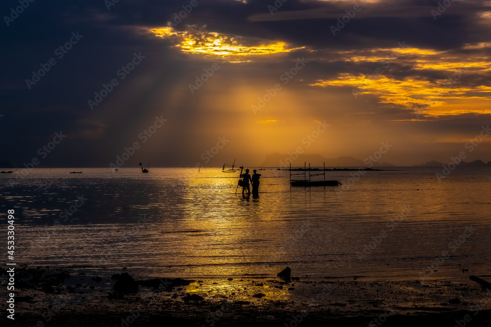 silhouette people on the sea , the sunshine ray over the beach , Bangmakam beach, koh samui,suratthani ,thailand