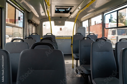 Leatherette seats in the empty cabin of a city public municipal bus. photo
