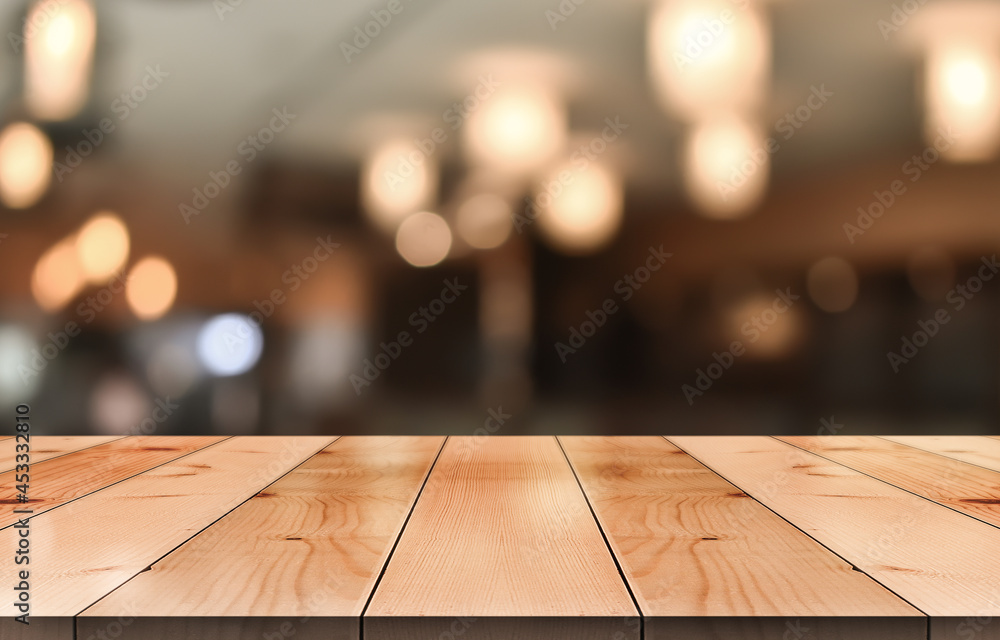 Empty wooden table top with lights bokeh on blur restaurant background. Empty wooden table top with lights bokeh on blur restaurant background.