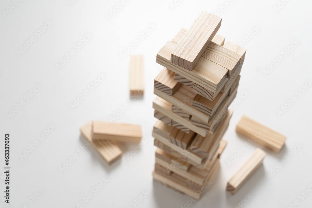 Closeup wood blocks stack game for planning, risk and strategy of project management in business concept Closeup wood blocks stack game for planning, risk and strategy of project management in business concept